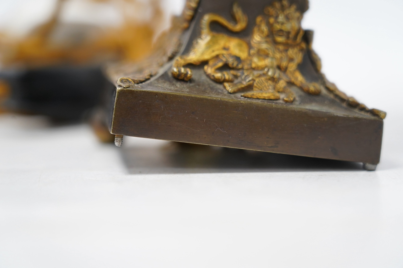 An ormolu table lamp in the form of an eagle with a laurel wreath around its neck, fitted with a grey shade, 39cm high overall. Condition poor to fair, three feet missing to lamp